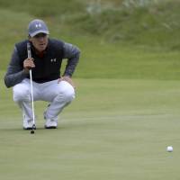 Jordan Spieth lines up a putt on the 14th hole during the first round of the British Open on Thursday. Spieth carded a 65 and is tied for the lead. Three tied atop leaderboard with 65s