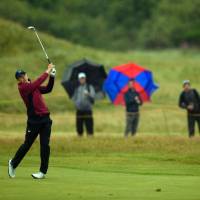 Jordan Spieth watches his shot from the fairway on the 16th hole during the second round of the British Open on Friday. Spieth carded a 69 and leads by two strokes. Spieth two up after 2nd round