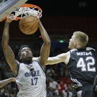 Jazz forward Eric Griffin dunks the ball against the Spurs’ Davis Bertans in a recent NBA Summer League Game in Salt Lake City. Jazz sign Griffin to two-way contract