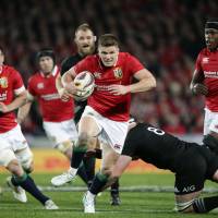 Lions center Owen Farrell runs at the All Blacks defense during the third test at Eden Park in Auckland on Saturday. All Blacks, Lions share series after tie in deciding test