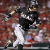 Miami’s Ichiro Suzuki runs to first base after hitting a single against St. Louis on Wednesday. Stanton homers twice to lead Marlins by Cards
