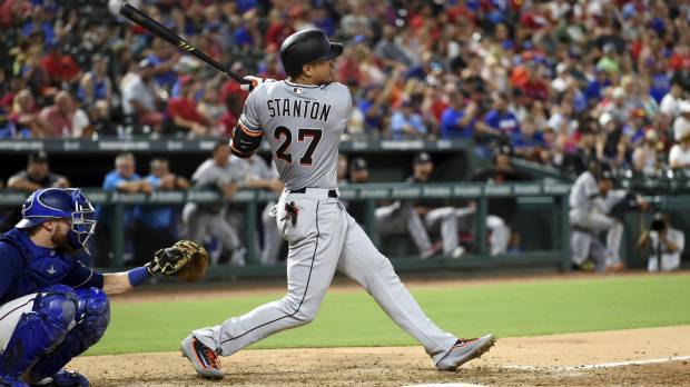 Miami’s Giancarlo Stanton watches his second home run against Texas on Monday night leave the yard in the eighth inning. Stanton stays hot, powers Marlins past Rangers