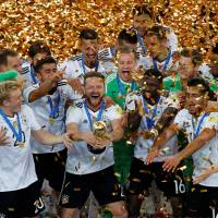 Germany’s Shkodran Mustafi holds the trophy while celebrating with his teammates after their 1-0 victory over Chile in the Confederations Cup final on Sunday in St. Petersburg, Russia. Germany beats Chile in bruising Confederations Cup final