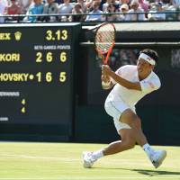 Kei Nishikori plays a shot from Ukraine’s Sergiy Stakhovsky in their second-round match at Wimbledon on Wednesday. Nishikori won 6-4, 6-7(7-9), 6-1, 7-6 (8-6). Nishikori into third round with win over Stakhovsky