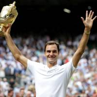 Roger Federer celebrates after winning his eighth Wimbledon title on Sunday in London. Federer gets record-breaking eighth Wimbledon title