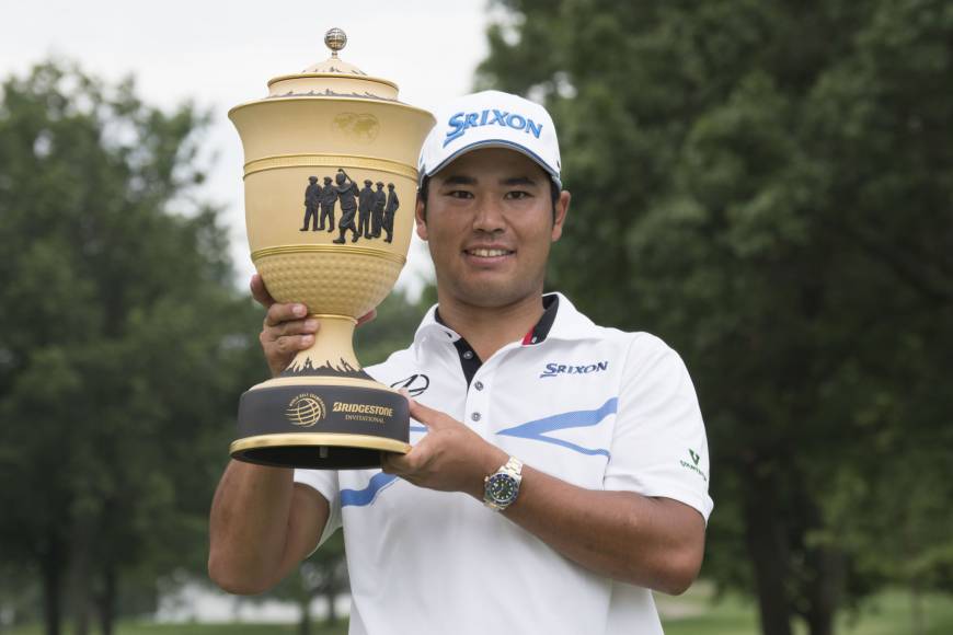 Hideki Matsuyama poses Sunday with the trophy after the final round of the WGC — Bridgestone Invitational golf tournament at Firestone Country Club in Akron, Ohio. Matsuyama matches record on way to victory at Bridgestone Invitational