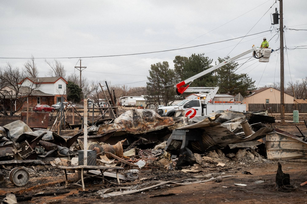 Homes destroyed and land scorched as Texas battles its largest wildfire ever