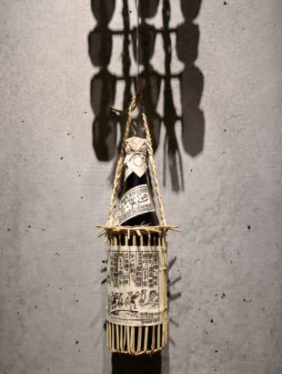 Rice straw has multiple uses, such as a carrying case for a sake bottle.