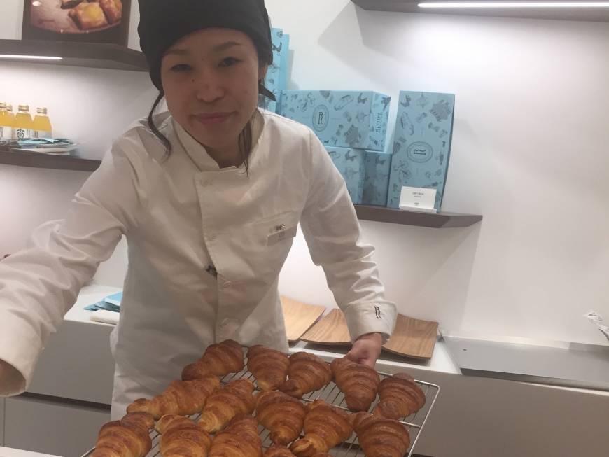 Staff at Rituel Par Christophe Vasseur hand out croissants.