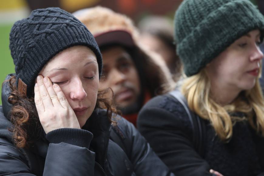 Bianca Soto wipes a tear from her eye while she pays her respects at the New York memorial.