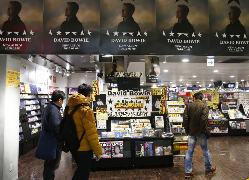 Shoppers look at a CD stand dedicated to David Bowie at a Tower Records store in Shibuya, Tokyo on Tuesday.