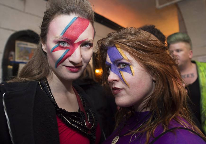 Bowie fans pose as they wait to hear collaborators Tony Visconti and Mick Woodmansey perform Bowie