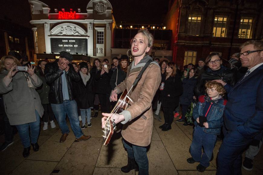 A fan sings Bowie songs to crowds outside the Ritzy cinema in Brixton.
