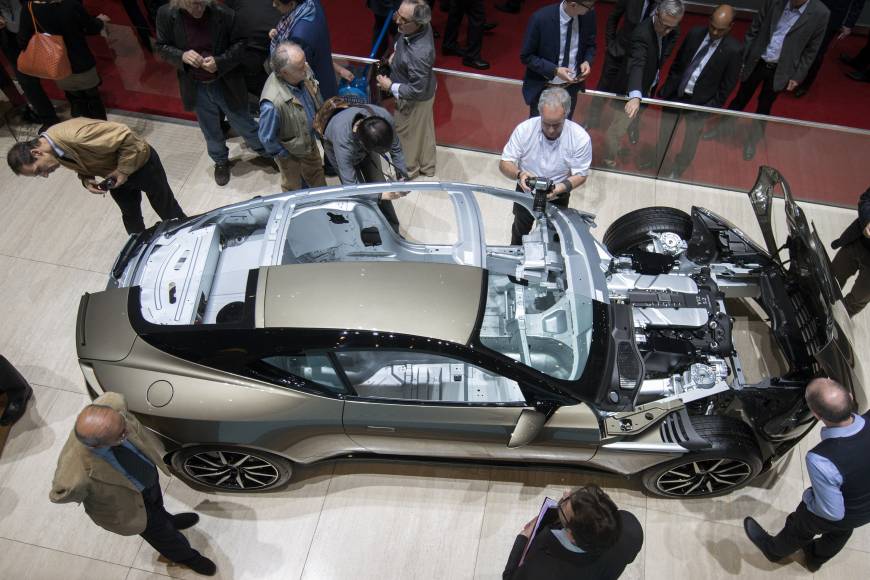 Journalists pore over a cut-down Aston Martin on the second press day of the 86th International Auto Show in Geneva on Wednesday. The show opened to the public on Thursday and runs until March 13. It has more than 200 exhibitors, and more than 120 product launches are expected.