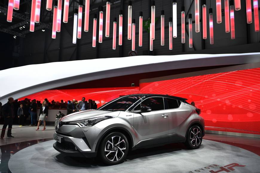 Visitors look at a Toyota C-HR Coupe High Rider at the stand of Japanese carmaker during the press day of the Geneva Motor Show.