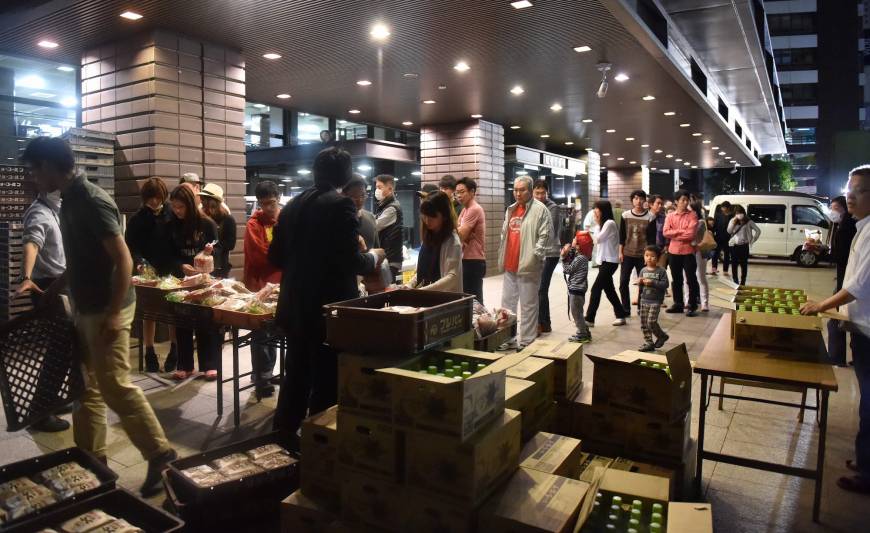 Evacuees queue for food supplies at an entrance of the Kumamoto City Hall on Saturday. 