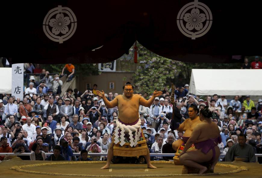 Yokozuna Hakuho performs a traditional ring-entering rite, called dohyo-iri.
