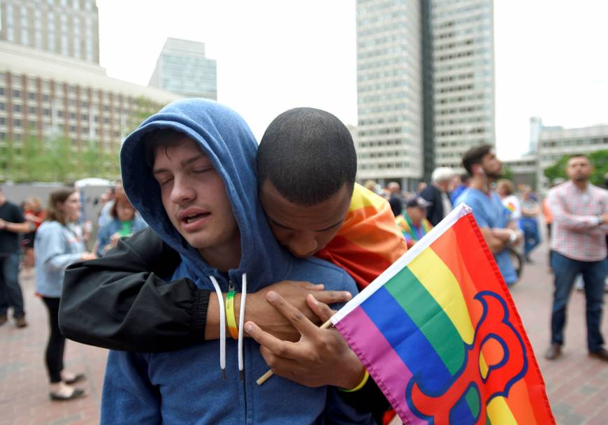 Chris Bartley (left) is hugged by Sam Johnson in Boston, Massachusetts.