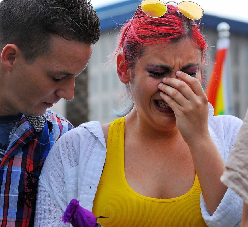 Shawn McCluskey comforts his girlfriend Freedanchy Ruiz in Orlando, Florida, over the death of her cousin Rodolfo Ayala.