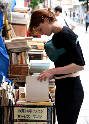 A shopper browses art books at a store selling used volumes in Tokyo’s Jinbocho neighborhood.