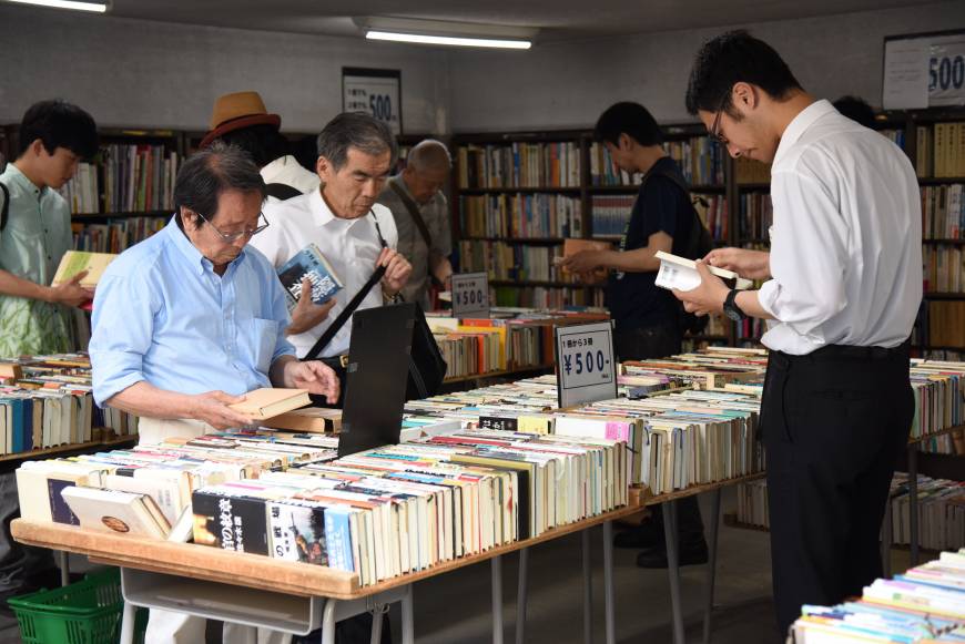 People browse used volumes at one of some 160 bookstores in Jinbocho in Tokyo’s Chiyoda Ward.