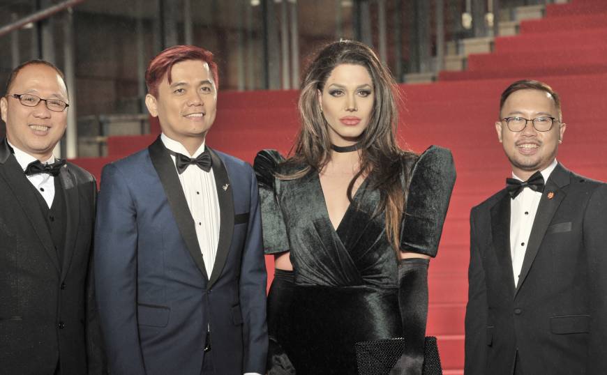 Filipino director Jun Lana (center left) and actor Paolo Ballesteros (center right), who transformed himself into Angelina Jolie for TIFF, with the creators of 