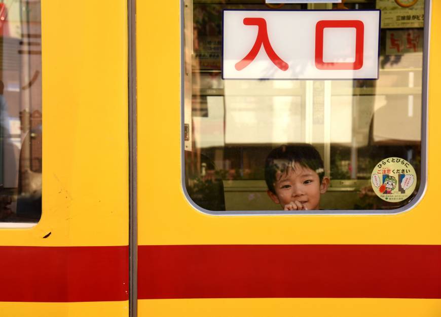 A boy peeks out from the window of a streetcar on Oct. 20.