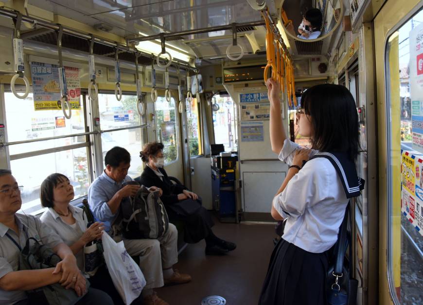 Passengers take a slow ride on the Toden Arakawa Line.