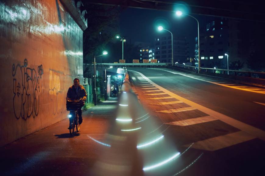 Silent streets: A man cycles along an empty sidewalk on the outskirts of Shibuya. | ANDREW CURRY
