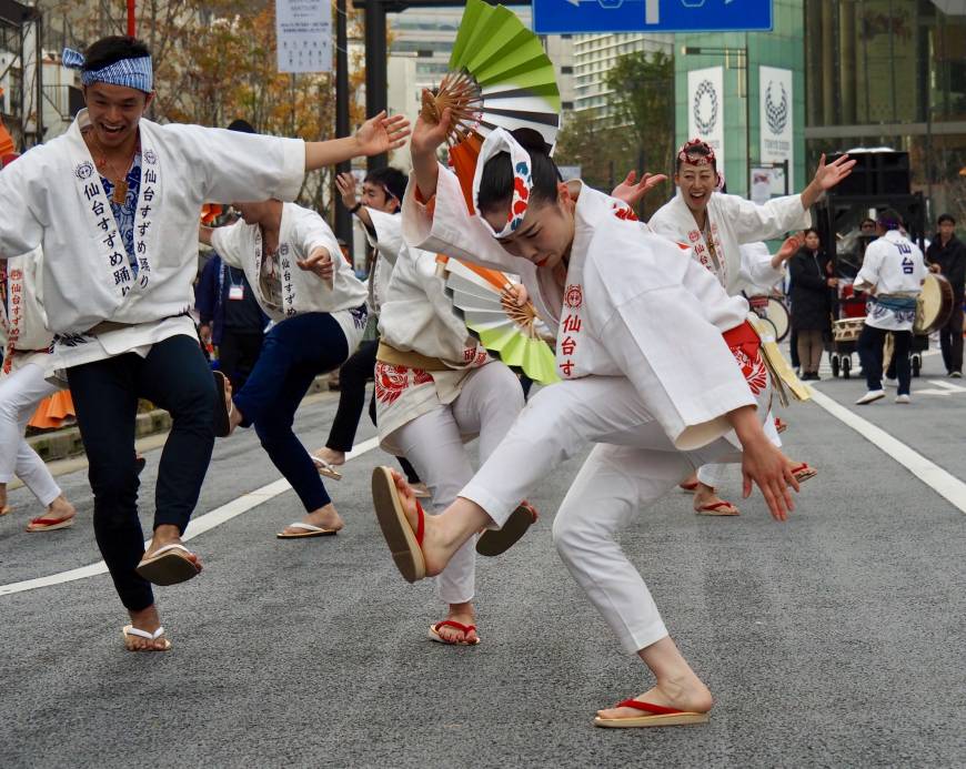 Dancers bearing fans perform the Sendai Suzume Odori. The lively folk dance traces its origins back to the sparrow-like movements of stonemasons celebrating completion of the Aoba Castle in 1637.