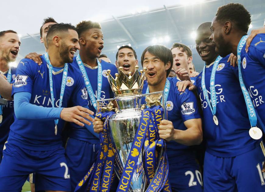 Members of Leicester City lifts the Premier League trophy.