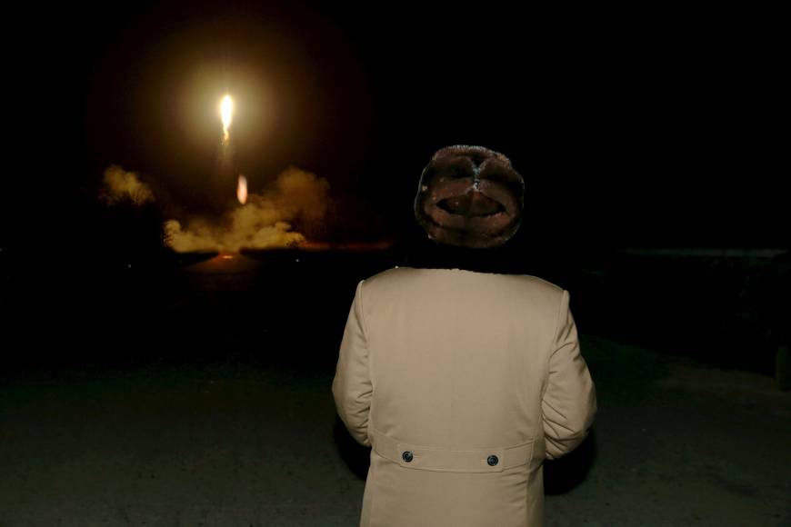 North Korean leader Kim Jong Un watches a ballistic rocket launch at an unknown location in an undated photo released in March.