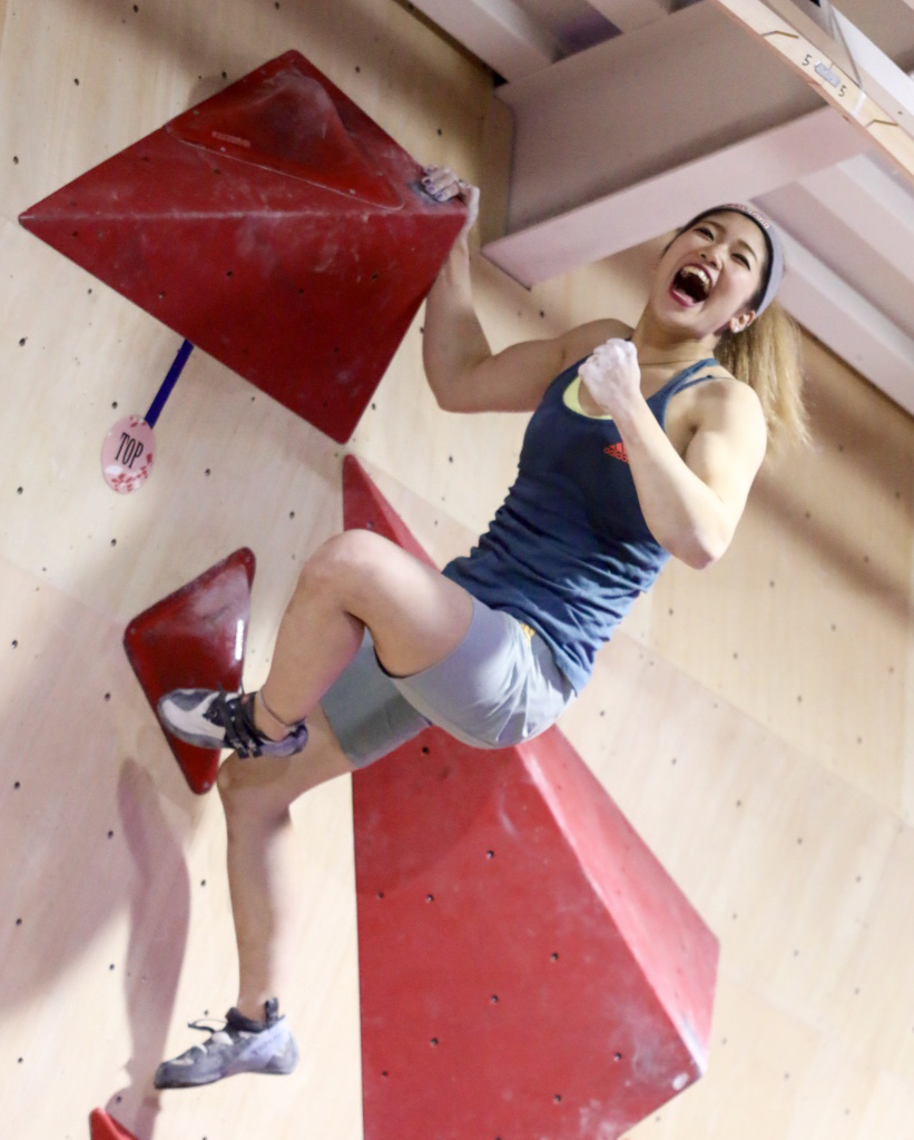 Miho Nonaka shows her sports climbing skills at a bouldering event in Tokyo in December. | KAZ NAGATSUKA