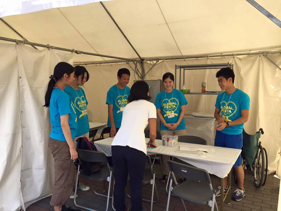 Members of student volunteer group Team Medics provide medical help at the Global Festa Japan event in October 2015. | COURTESY OF TEAM MEDICS