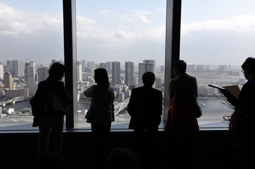 Visitors view Tokyo Bay, including the Harumi and Odaiba waterfront districts, from an observatory about 200 meters above street level Feb. 20 in Minato Ward, Tokyo.