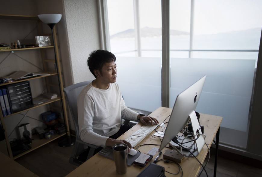 Kazz Watabe moved to the city of Fukuoka from Tokyo in late 2013 to develop smartphone apps and software. He can now see sea bass jump as he works on his website from his beachfront office.