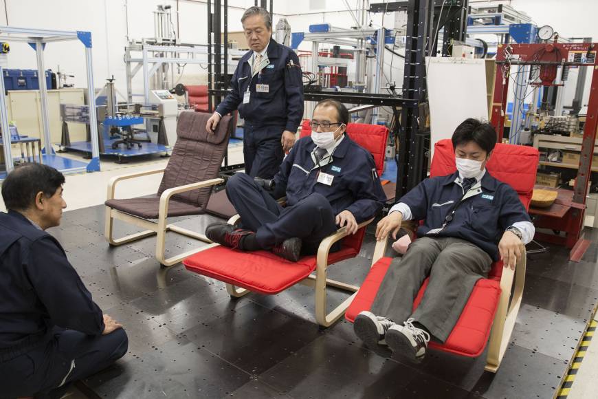 Members of a Nitori Holdings Co. quality control team try different methods of sitting on chairs during a product test in Tokyo on April 25.