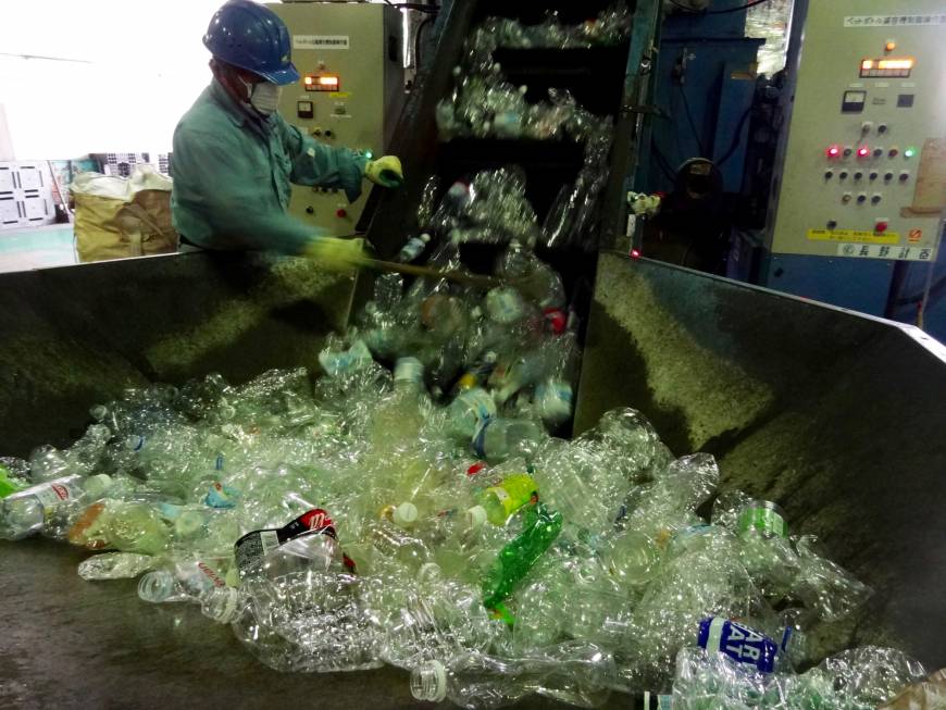 PET bottles are put into a compressor at the Minato Resource Recycle Center in Tokyo.