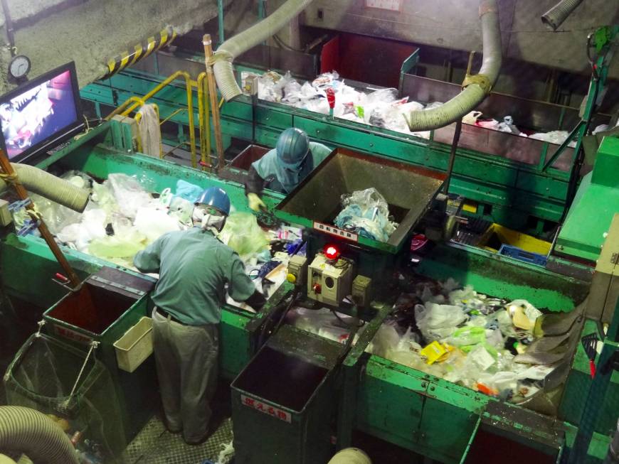 Workers sort plastic waste at the Minato Resource Recycle Center in Tokyo.