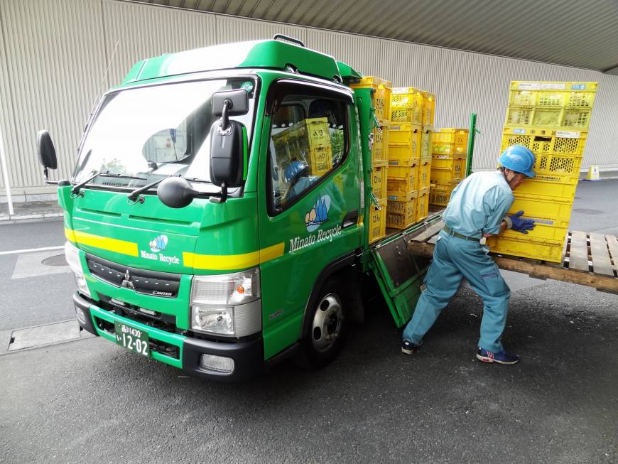 Crates of bottles are unloaded at the Minato Resource Recycle Center in Tokyo.