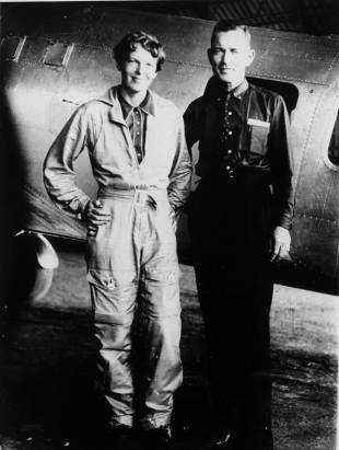 Amelia Earhart and her navigator, Fred Noonan, pose for a photo in front of their twin-engine Lockheed Electra in Los Angeles at the end of May 1937.