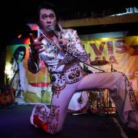 Elvis Presley impersonator Jun Espinosa, of the Philippines, performs during the finals of the first Elvis in Asia contest in Manila on Saturday. | AFP-JIJI