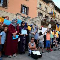 Relatives of suspects of the attacks in Barcelona and Cambrils gather with members of the local Muslim community as they take part in a rally to denounce terrorism in front of Ripoll\'s townhall, Spain, Sunday. | REUTERS