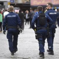 Police officers patrol at Turku Market Square in Turku, Finland, on Saturday. | REUTERS