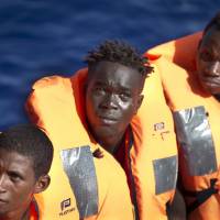 African migrants rescued by an oil rig supply ship are transferred to the Aquarius vessel of SOS Mediterranee and MSF (Doctors Without Borders) NGOs, in the Mediterranean Sea north of Libya Wednesday. | AP