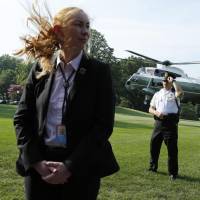 U.S. Secret Service agents stand guard as Marine One, with President Donald Trump on board, departs the White House in Washington on July 22. | AFP-JIJI