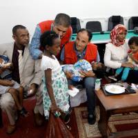 Members of Libyan Red Crescent hand over the children of Sudanese Islamic State members who operated in Libya, to a Sudanese official, in Misrata, Libya, Sunday. | REUTERS