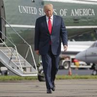 President Donald Trump walks across the tarmac from Marine One to board Air Force One at Morristown Municipal Airport in Morristown, New Jersey, Monday. Bombarded by the sharpest attacks yet from fellow Republicans, Trump on Thursday, dug into his defense of racist groups by attacking members of his own party and renouncing the rising movement to pull down monuments to Confederate icons. | AP