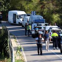 Catalan Mossos d\'Escuadra vans are parked along a road near the place where Younes Abouyaaqoub, the man suspected of driving the van that killed 13 people in Barcelona last week, was killed by police in Sant Sadurni d\'Noia, Spain, Monday. | REUTERS
