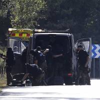 Members of TEDAX-NRBQ (Technician Specialist in Deactivation of Explosive Artifacts) inspect the site where Moroccan suspect Younes Abouyaaqoub was shot on Monday near Sant Sadurni d\'Anoia, south of Barcelona, four days after the Barcelona and Cambrils attacks that killed 15 people. Spanish police said they have identified the driver of the van that mowed down pedestrians on the busy Las Ramblas boulevard in Barcelona, killing 13. The 22-year-old Moroccan Younes Abouyaaqoub is believed to be the last remaining member of a 12-man cell still at large in Spain or abroad, with the others killed by police or detained. | AFP-JIJI